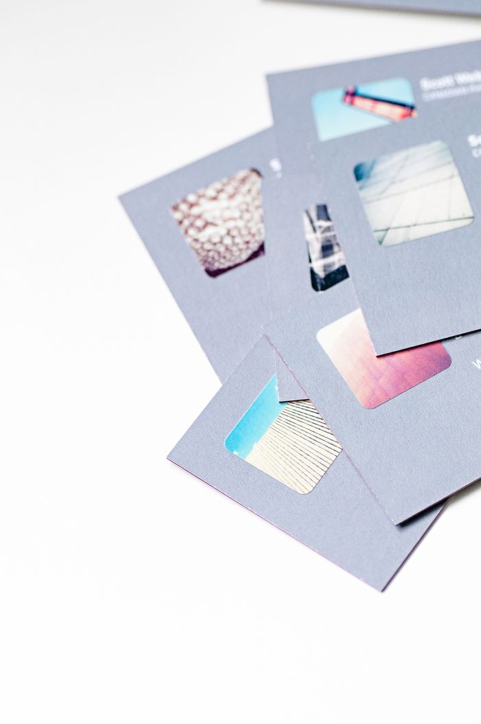 services-01 High angle view of abstract design business cards with cutouts on a white background.