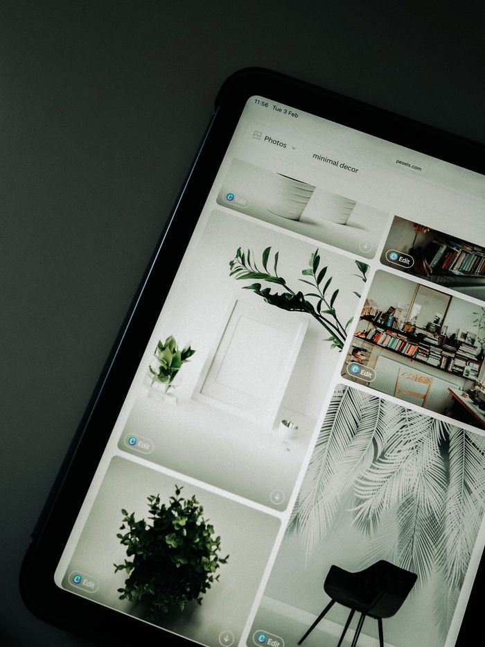 services-02 A tablet screen featuring images of minimalist decor emphasizing greenery and simple design.